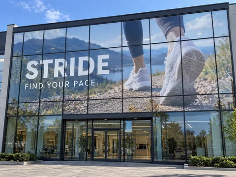 Lion Sign — Large-format digitally printed window vinyl and custom glass façade graphics for sports retail.