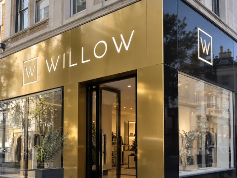 Lion Sign — Gold-and-black composite retail signage with CNC-cut white acrylic lettering.