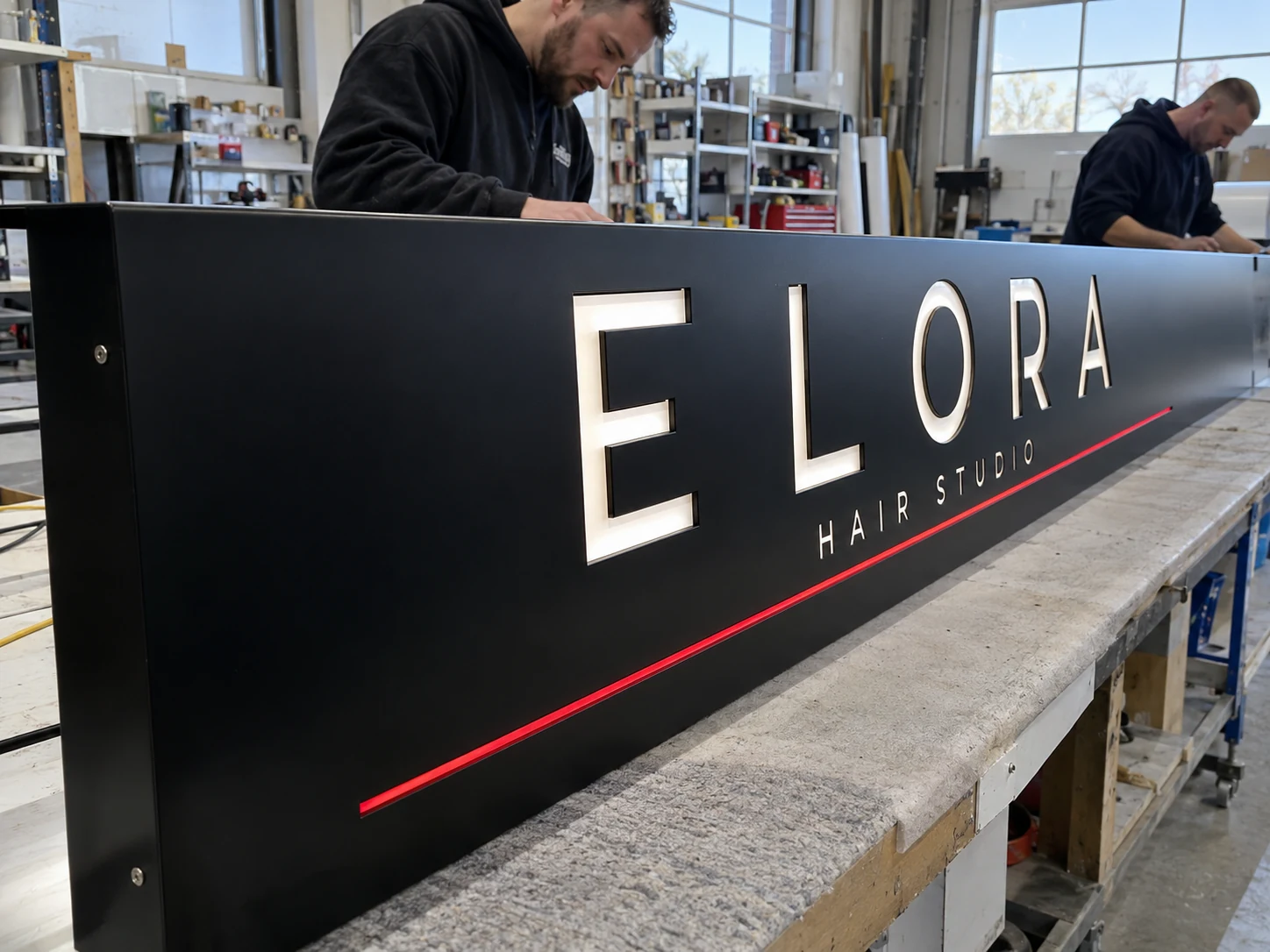Lion Sign — CNC-routed black aluminium composite fascia with precision-fitted white acrylic letters.