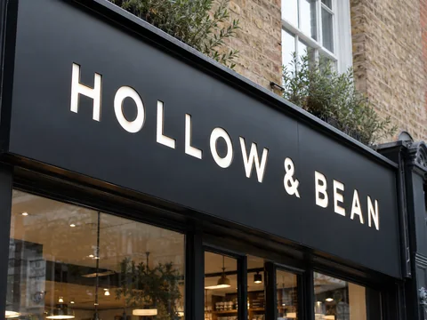 Lion Sign — CNC-routed black aluminium composite café signage with white acrylic inset letters.