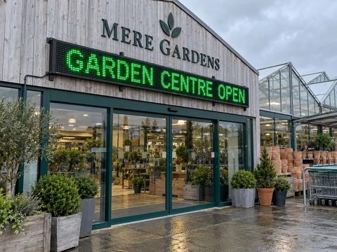 Lion Sign — Green LED opening-hours message board for garden centres.